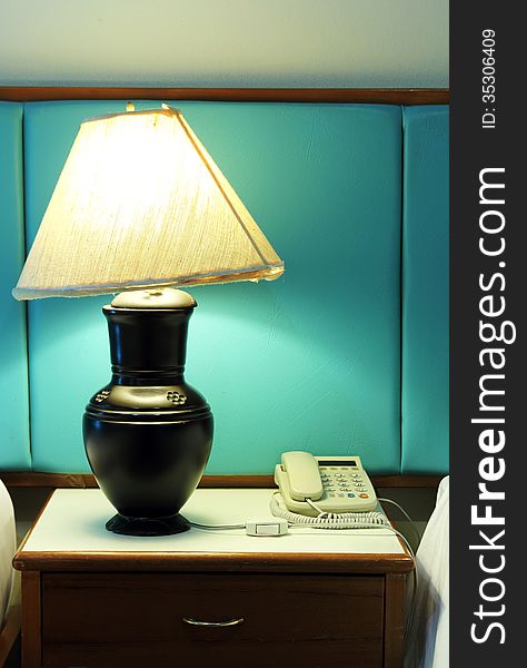 Table lamp and phone on bedroom