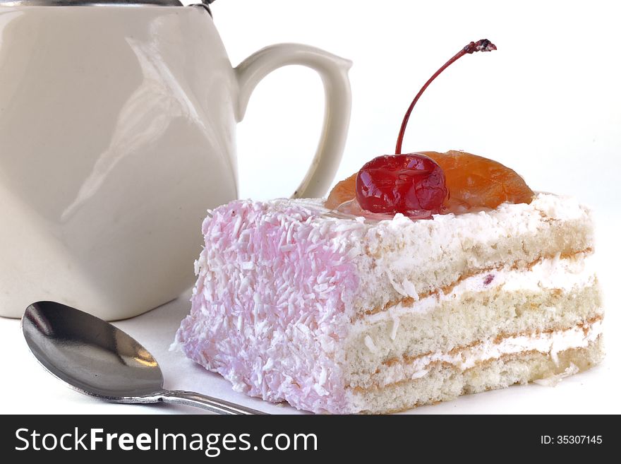 Sliced cake, kettle and teaspoo isolated on white background
