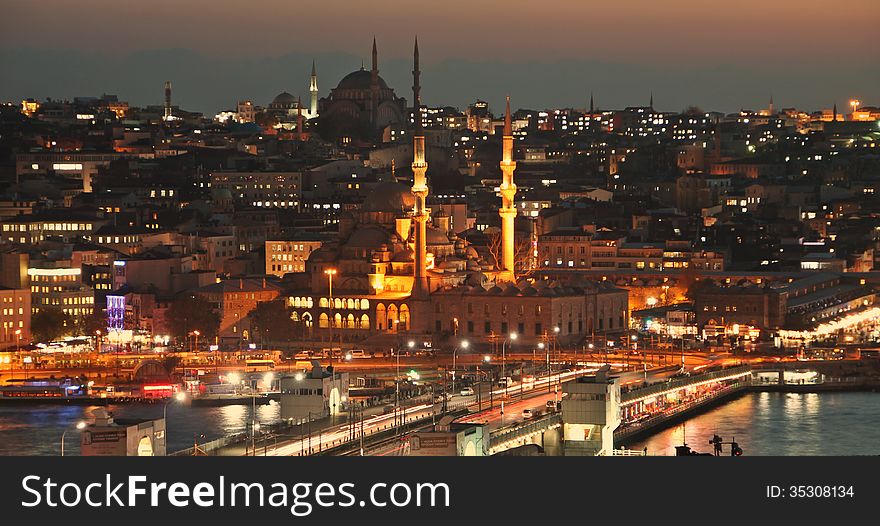 Istanbul Turkey Galata bridge at rush hour, mosque and Eminönü ferry pier by night. Istanbul Turkey Galata bridge at rush hour, mosque and Eminönü ferry pier by night