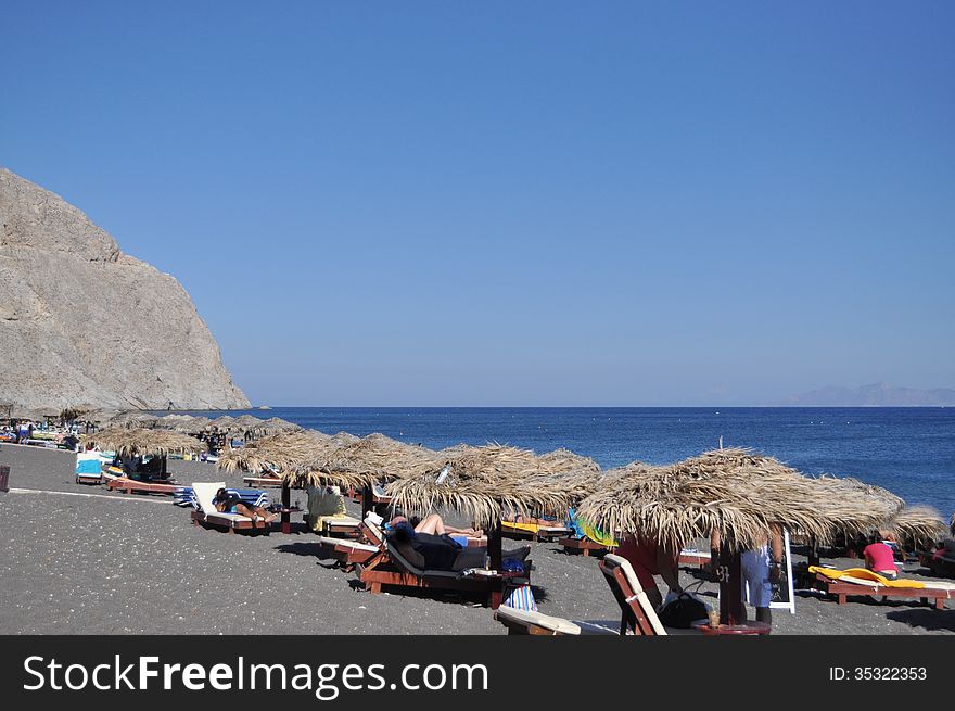 Aegean sea, the island of Santorini. Greek Mediterranean landscape: the rock, beach, sea.