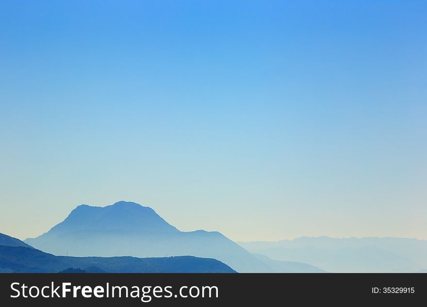 Silhouettes of different tones of blue under clear blue sky. Silhouettes of different tones of blue under clear blue sky