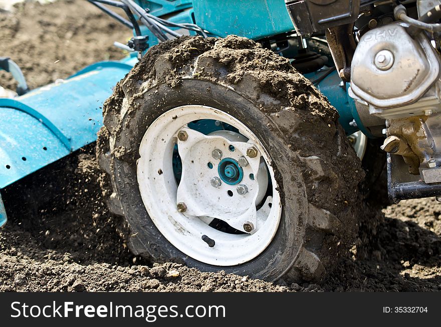 Powerfull tiller ploughing the soil