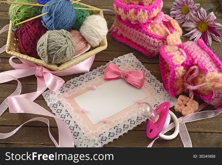 Pink greeting card with baby knitting things