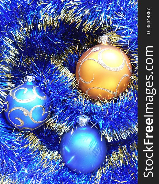 Christmas and New Year balls blue and gold tinsel background. Christmas and New Year balls blue and gold tinsel background