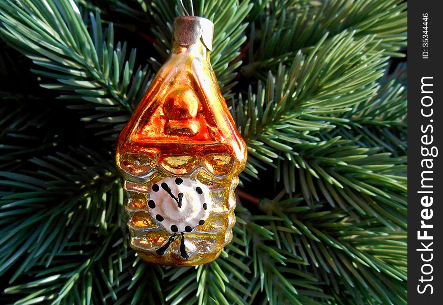 Christmas and New Year decoration gold watch on a background of green firtree