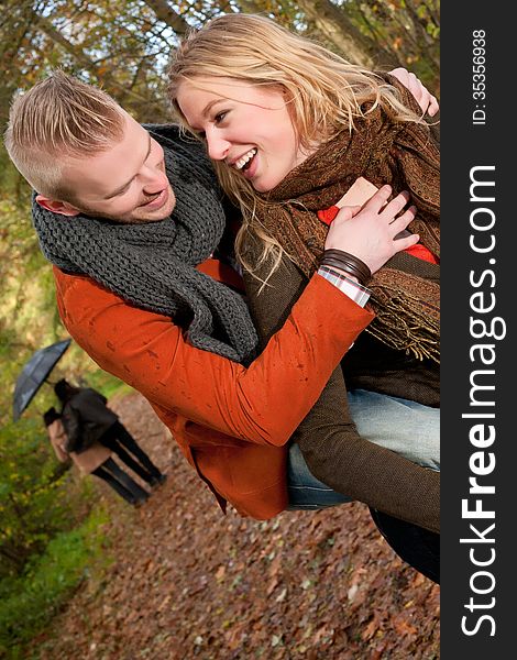 Young couple is having fun in the rain