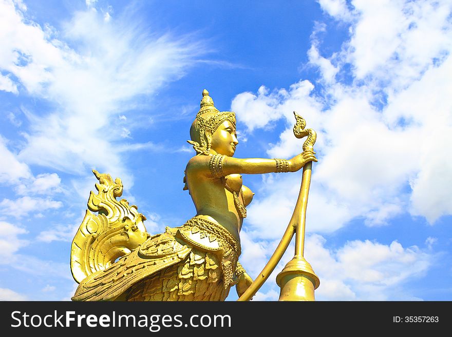 Golden Kinnari lighting pole and Blue sky with clouds in Thailand