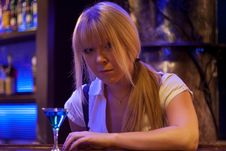 Young Woman Siting Alone At Bar Drinking A Cocktail Looking At Camera Royalty Free Stock Image Young Woman Siting Alone At Bar Drinking A Cocktail Looking At Camera Royalty Free Stock Image