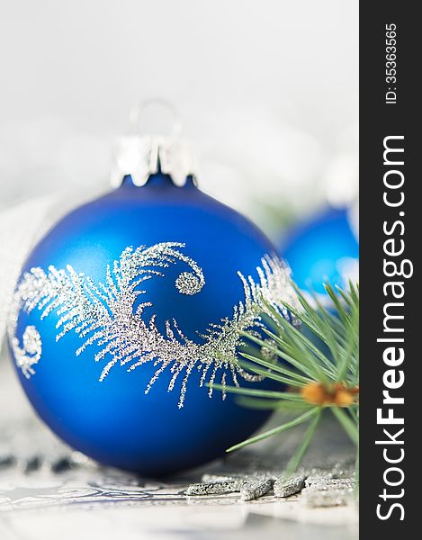 Blue and silver xmas ornaments on bright holiday background