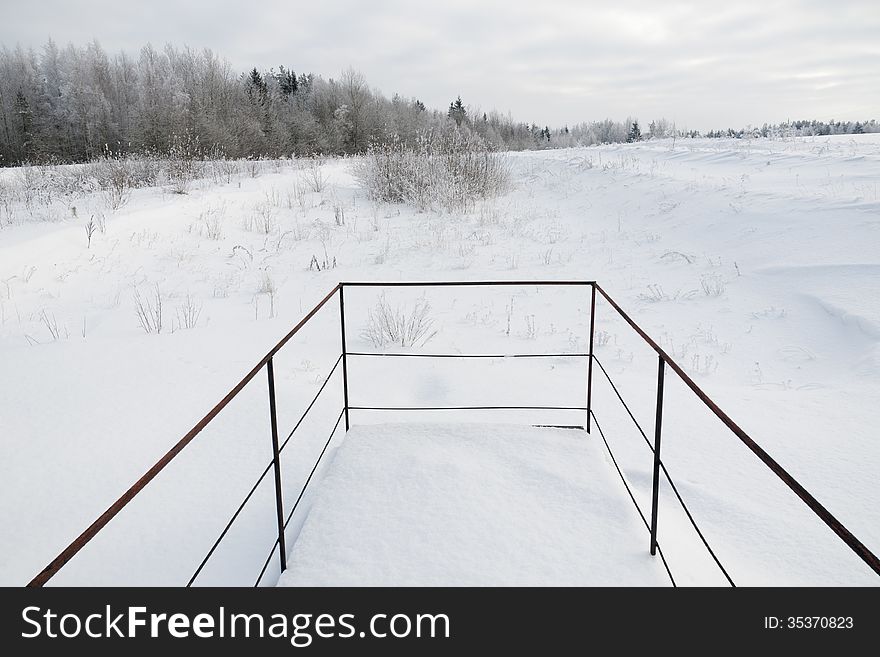 Metallic handrails with winter landscape behind