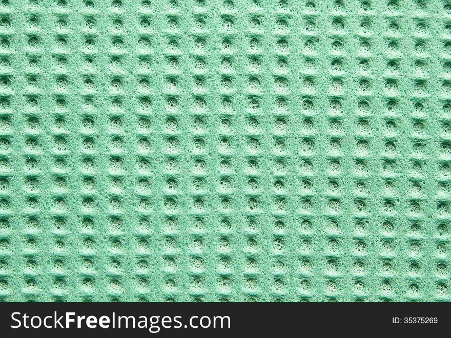 Green texture cellulose kitchen sponge as background. Green texture cellulose kitchen sponge as background