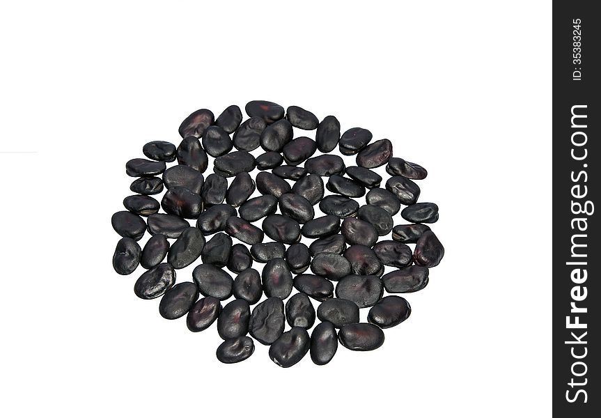 Black beans on a light background. Lie in the shape of a circle. Black beans on a light background. Lie in the shape of a circle