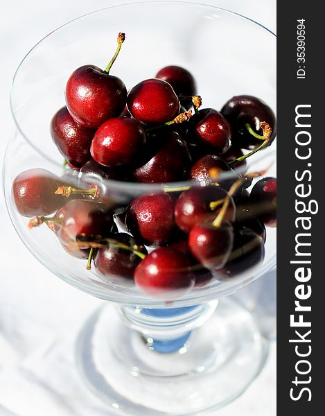Side and top view of glass bowl of red cherries. Side and top view of glass bowl of red cherries.