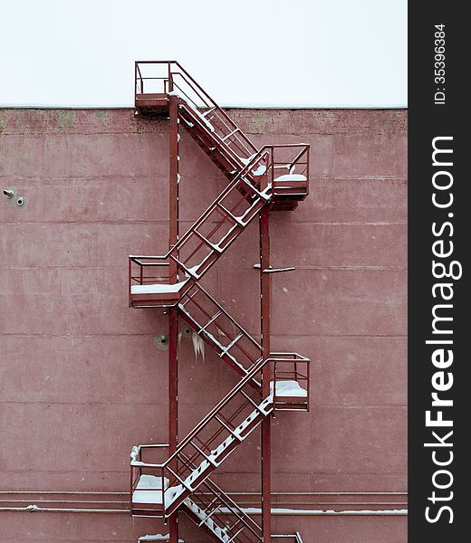 Metallic industrial stairs covered by snow