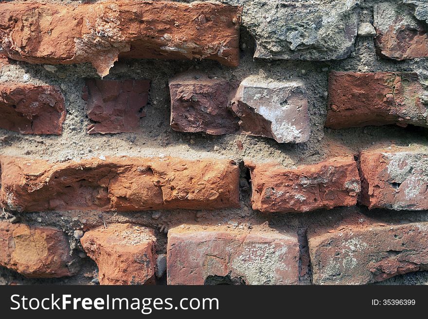 Closeup fragment of old ruined brick wall