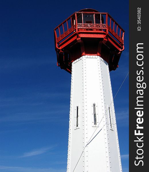 Lighthouse in white and red against a beautiful blue sky,Saint-Vaast,Normandy,France,Europe