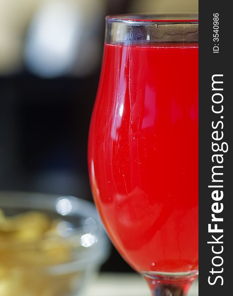 Close up of a glass ful of red orange juice.Shallow depth of field.
