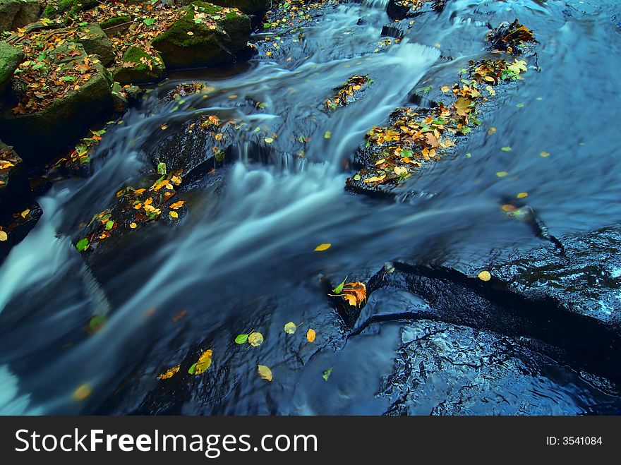 Mountain wood stream in an autumn forest. Mountain wood stream in an autumn forest