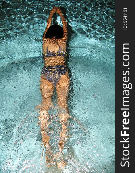 Sport photo, girl sliding in the swimming pool at night. Sport photo, girl sliding in the swimming pool at night