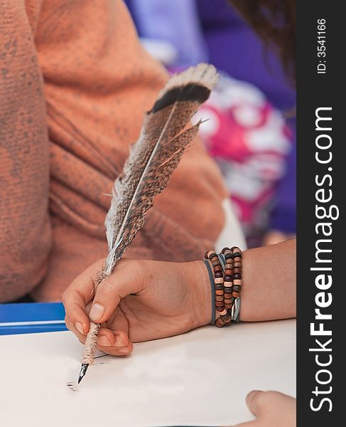 Close-up of a sketcher using a quill to draw on a piece of paper.Shot with Canon 70-200mm f/2.8L IS USM. Close-up of a sketcher using a quill to draw on a piece of paper.Shot with Canon 70-200mm f/2.8L IS USM