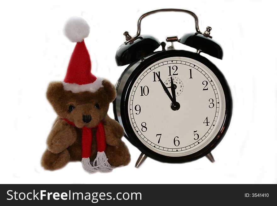 Teddy bear in christmas red cap and old alarm clock. Teddy bear in christmas red cap and old alarm clock