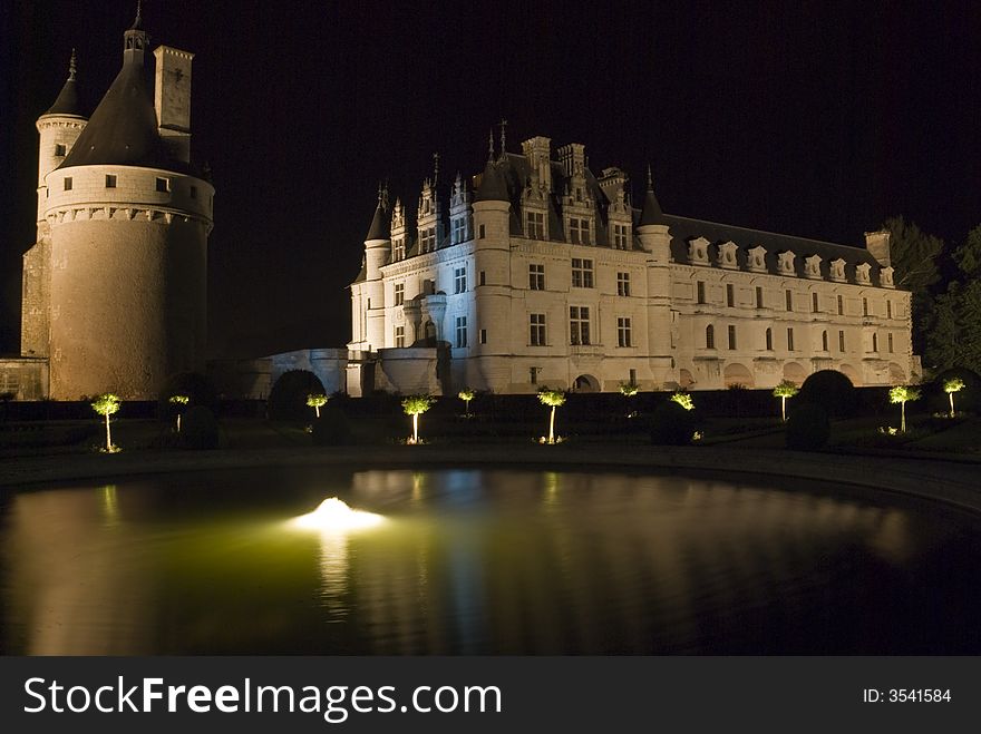 Night illumination of a fountain in the garden of the famous castle Chenonceau. Loire Valley, France. Night illumination of a fountain in the garden of the famous castle Chenonceau. Loire Valley, France.