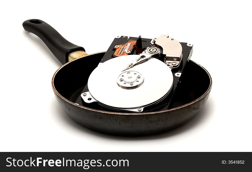 An exposed hard drive in a frying pan. A cooked hard drive!