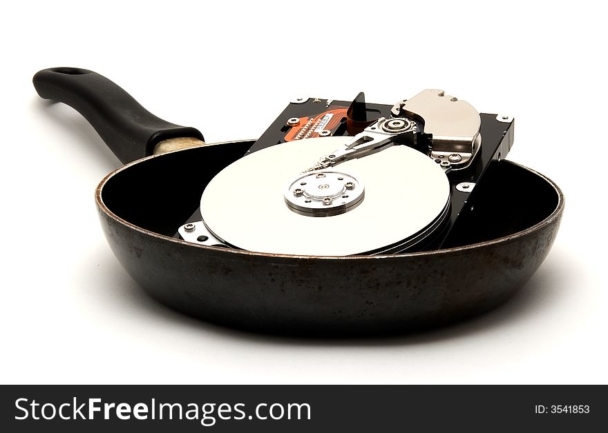 An exposed hard drive in a frying pan. A cooked hard drive!