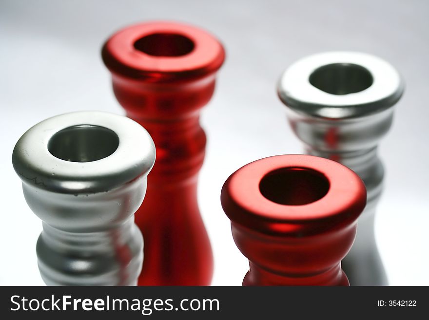 Four red and silver circles - top parts of candle holders. Four red and silver circles - top parts of candle holders.