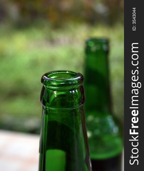 Neck of a bottle made of dark green glass. Neck of a bottle made of dark green glass