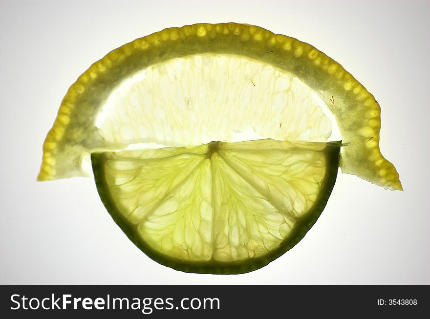 Lime and lemon slices, isolated and backlit with white backdrop, contacted