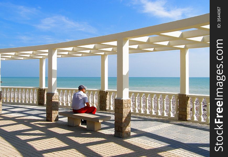 The man meditating in summerhouse near Mediterranean sea. The man meditating in summerhouse near Mediterranean sea