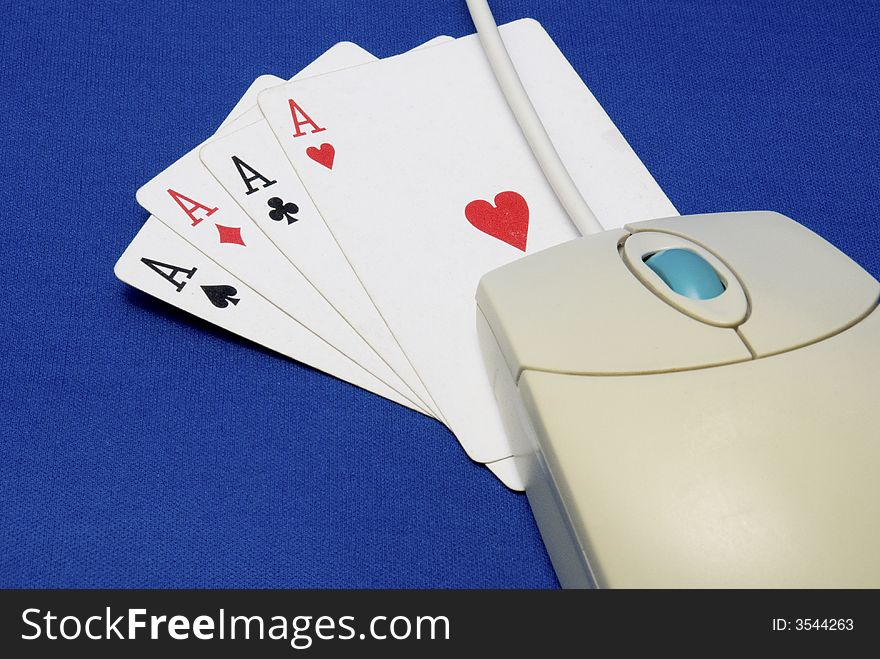 A computer mouse with playing cards showing 4 aces. A computer mouse with playing cards showing 4 aces.