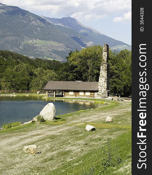 Small wooden cottage in Swiss Alps on the lake