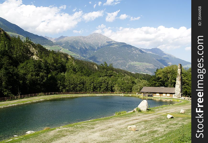 Wooden cottage on the lake in alps.