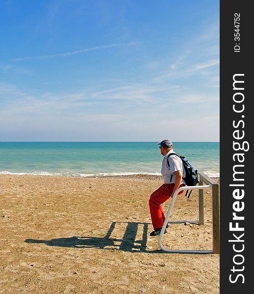 The man relaxing near tranquil Mediterranian sea. The man relaxing near tranquil Mediterranian sea