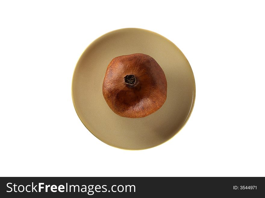 Pomegranate on the  plate isolated