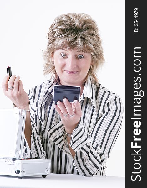 Woman applying lipstick with white background