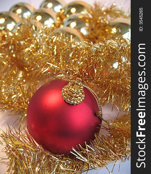Red christmas ball on golden christmas balls background