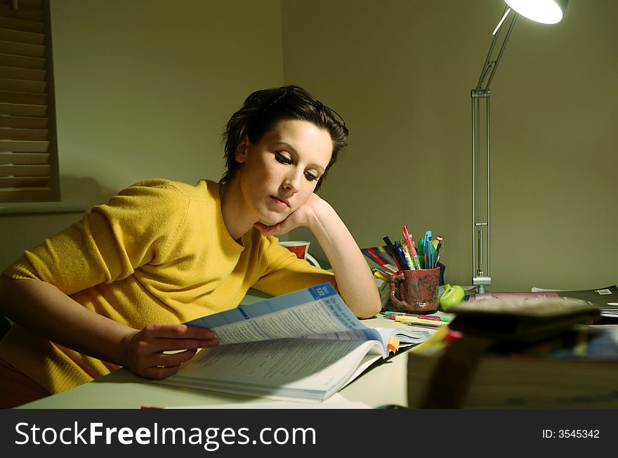 Young student at a desk preparing for an exam. Young student at a desk preparing for an exam