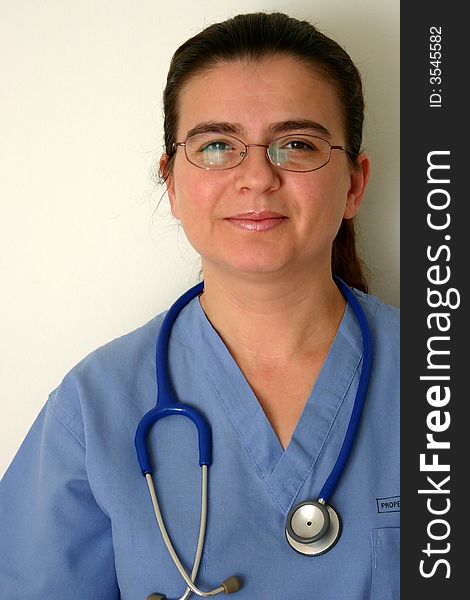 A doctor or nurse in scrubs and stethoscope around neck