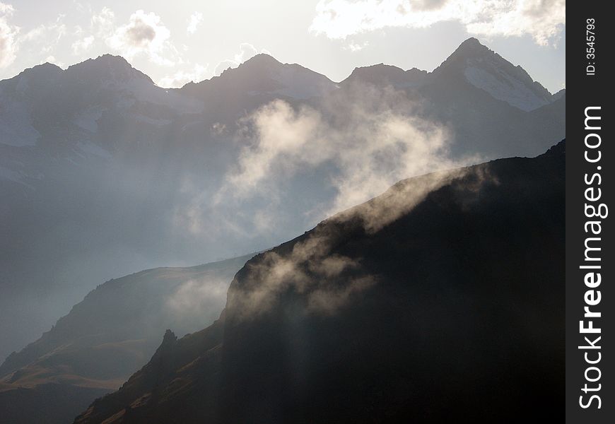 Sihouette of mountains with light clouds