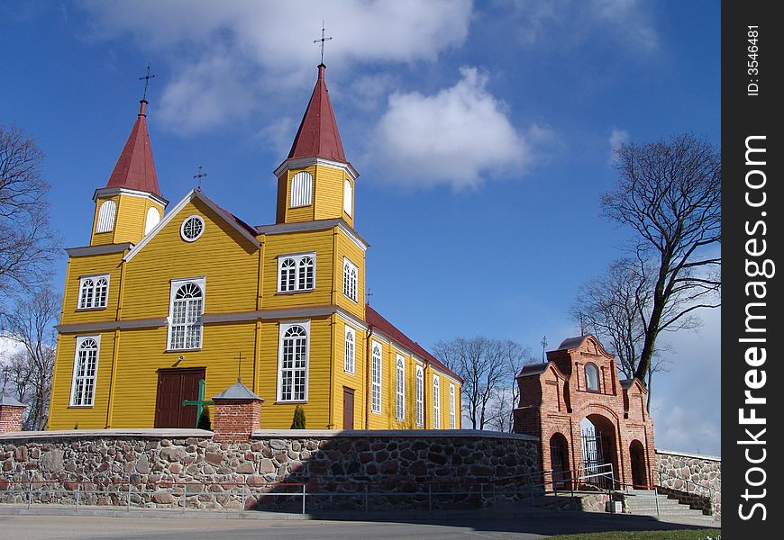 Yellow wooden church with two towers