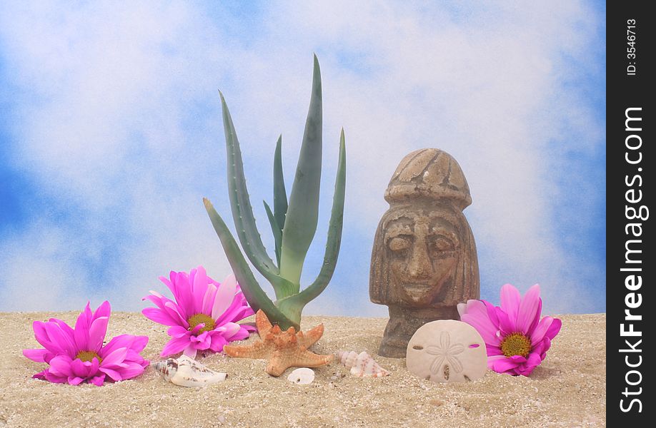 Aloe Plant and Statue on Sand With Blue Sky Background. Aloe Plant and Statue on Sand With Blue Sky Background
