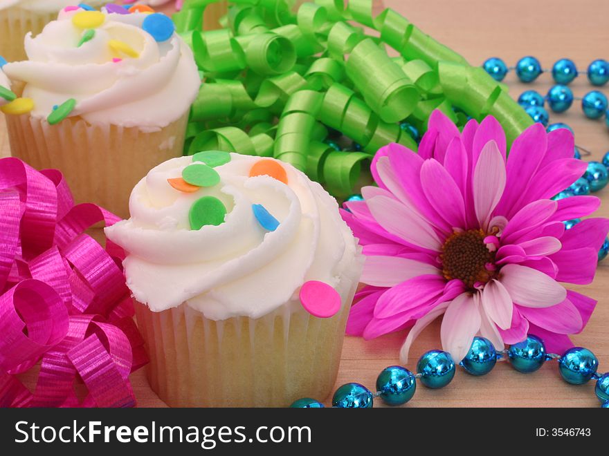 Cupcakes and Flower with Beads and Ribbon on Wooden Table. Cupcakes and Flower with Beads and Ribbon on Wooden Table