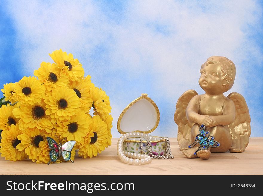 Flowers and Angel with Butterflies and Jewelry Box on Blue Sky Background