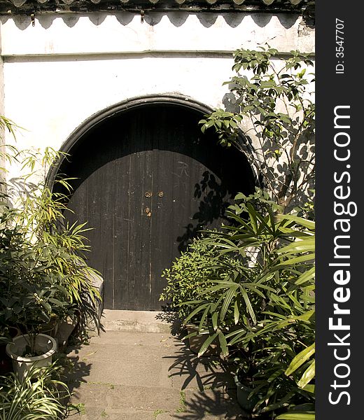 Wooden chinese garden door and green bamboo leaves. Wooden chinese garden door and green bamboo leaves