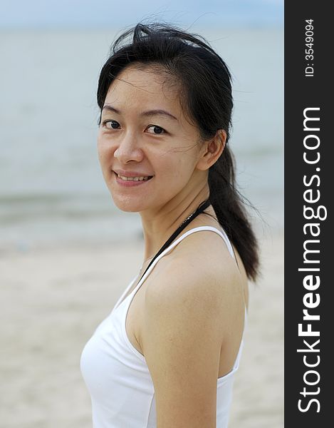 Chinese lady smiling at the beach. Chinese lady smiling at the beach.