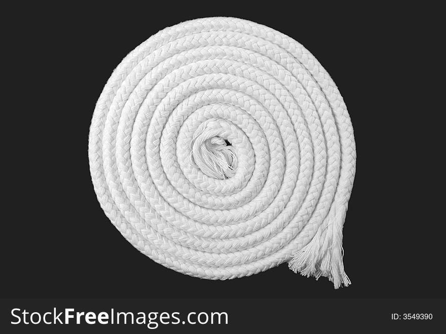 White plaited woolrope roll on grey background.