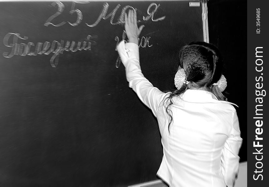 Scoolgirl near the black-board. Last lesson.